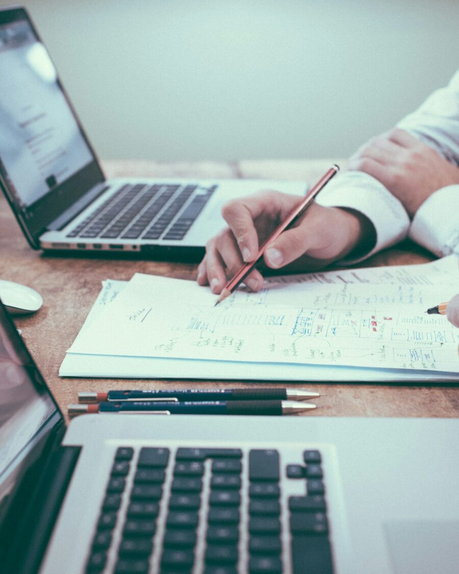Planning notes beside a laptop
